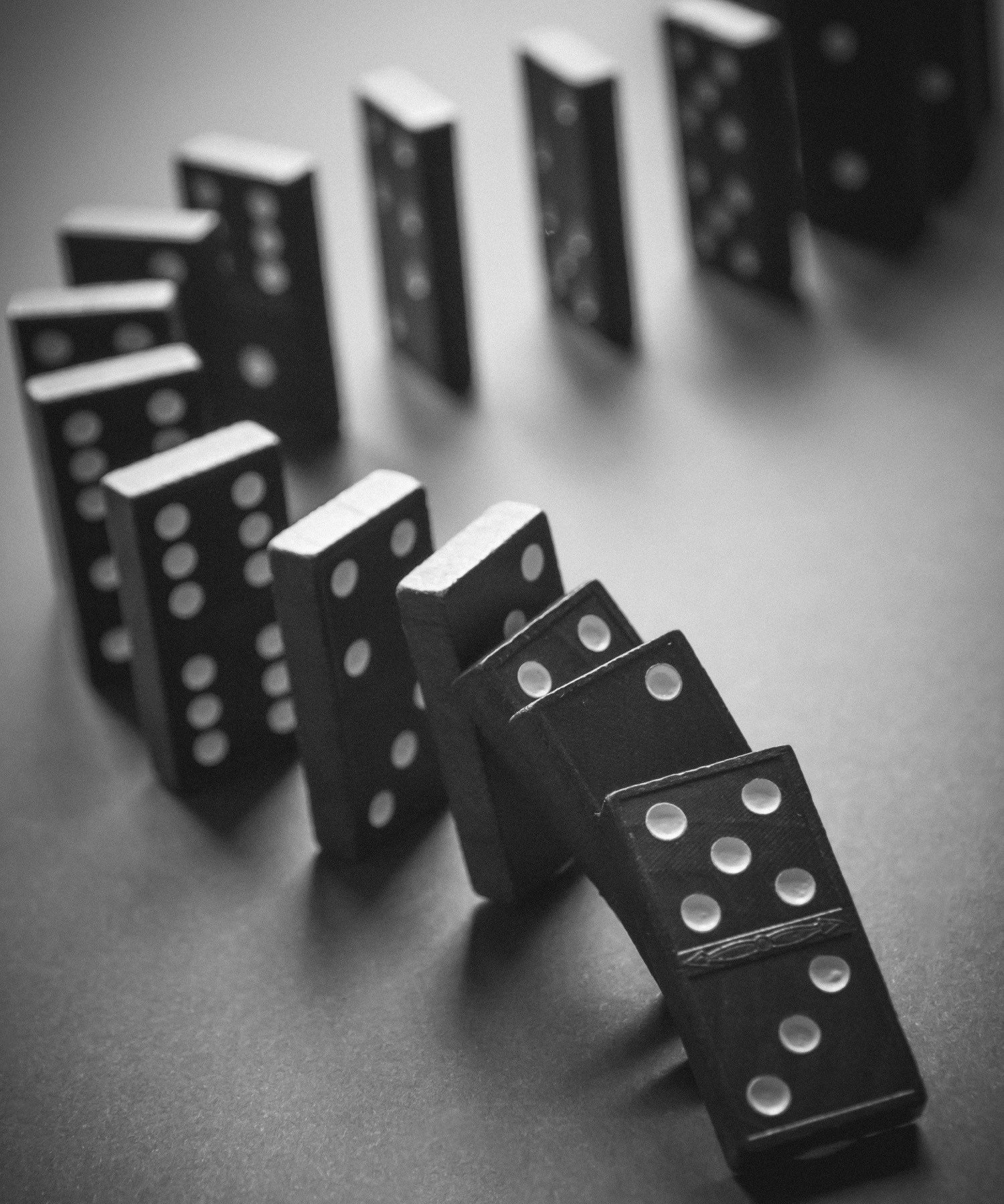 A row of dominoes toppling one after another
